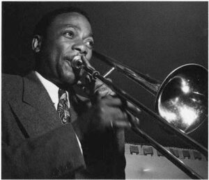 Photo of JC Higginbotham with trombone between 1946 and 1948